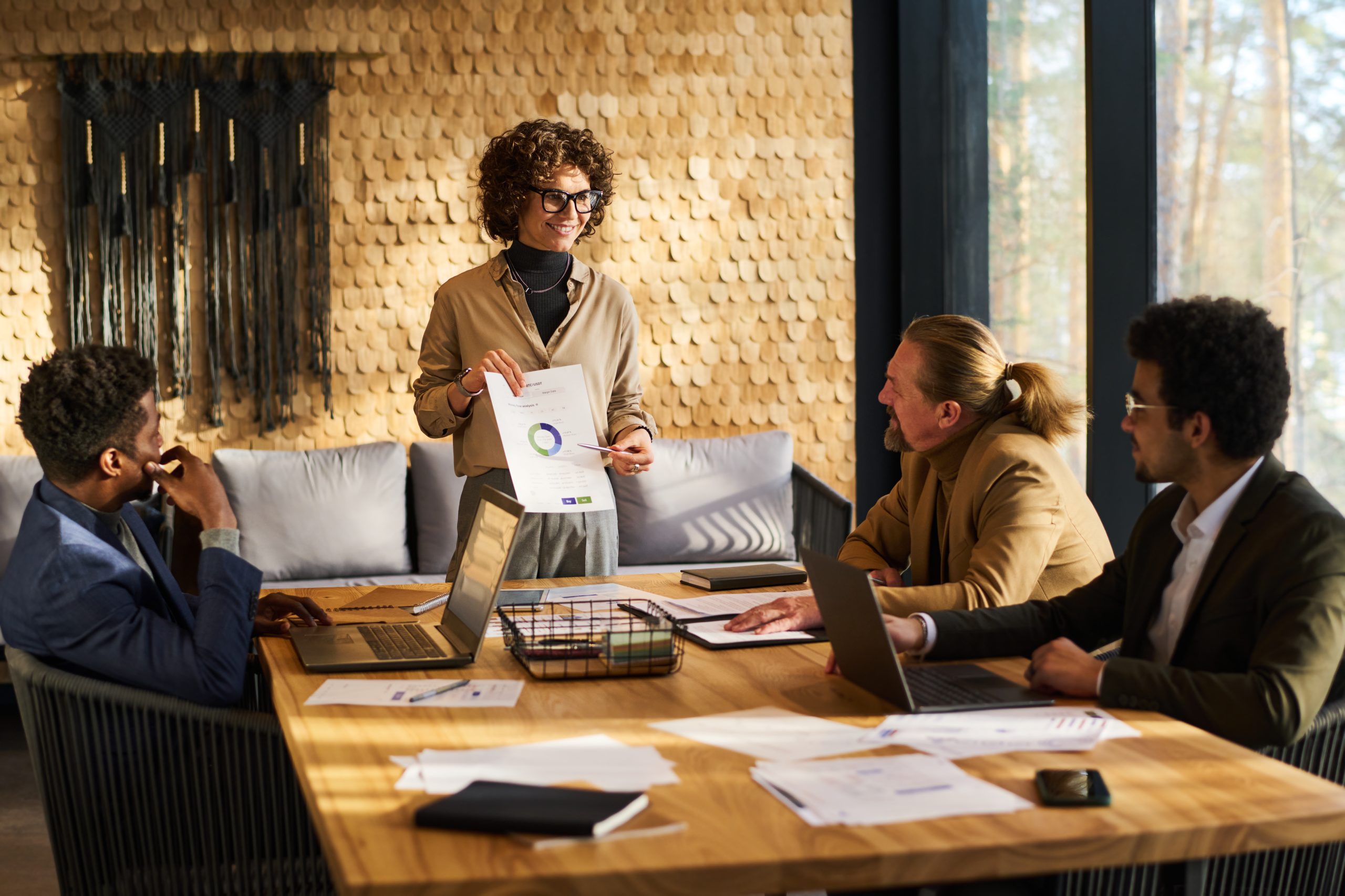 Business Coach pointing at financial document
